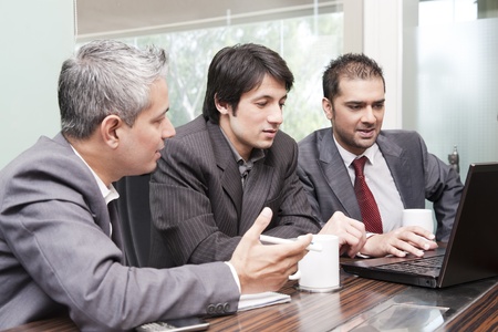three business men with diversed ethnicity in an official meetingの写真素材
