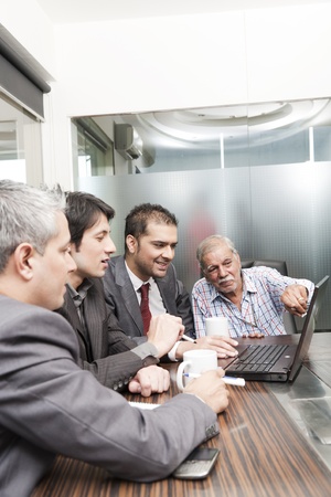 A diversed group of young business executives having a meeting with a senior executiveの写真素材