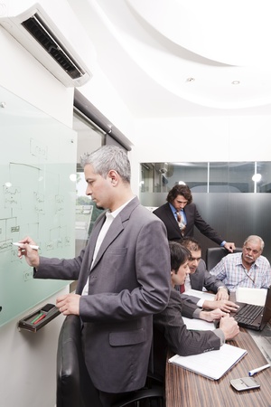 young businessman giving presentation to his colleaguesの写真素材