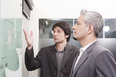 young businessman giving presentation to his colleaguesの写真素材