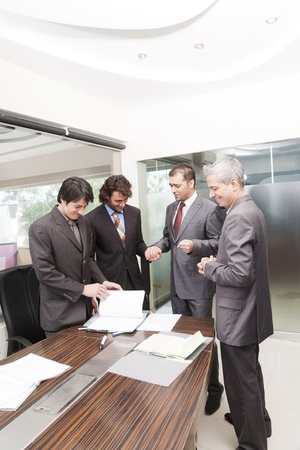 Group of happy businessmen having a casual discussion after the official meeting.の写真素材