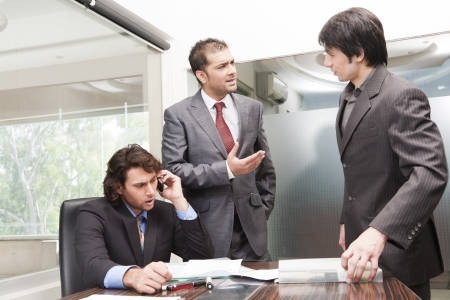 group of young businessmen having a serious and intense discussion in the business meeting.の写真素材