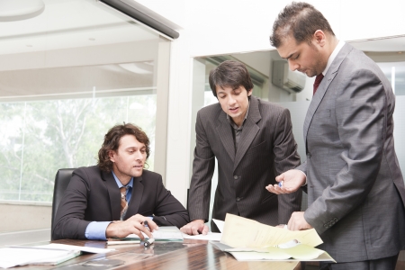group of young businessmen having a serious and intense discussion in the business meeting の写真素材