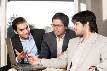group of multi ethnic businessmen, indian businessman in a meeting with his colleaguesの写真素材