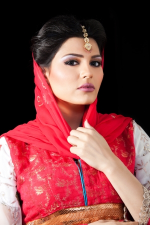 portrait of a beautiful muslim bride in red dressの写真素材