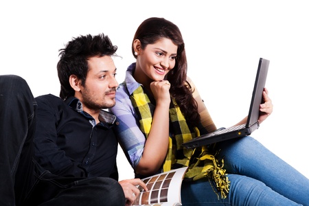 young couple selecting the flooring for the new home,happy young couple using laptop isolated on white, multi ethnic couple isolated on white の写真素材