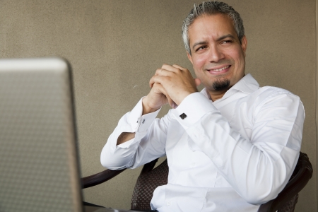 portrait of a happy successful businessman with grey hair working on the laptop, Indian muslim businessman working の写真素材