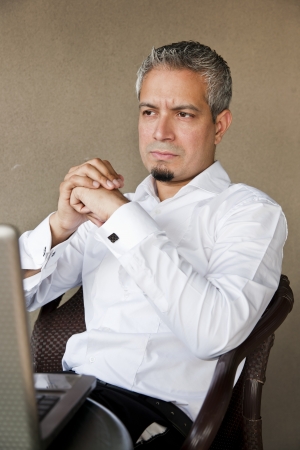portrait of a handsome businessman with grey hair working on the laptop, Indian muslim businessman working の写真素材
