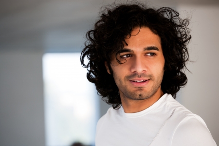 portrait of happy confident man with curly hair, portrait of confident hispanic man with copy space.の写真素材