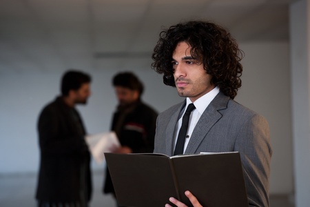 mixed race businessman standing in the office hall, portrait of a busineeman with copy space の写真素材