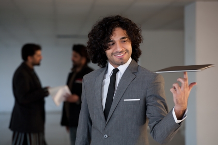 mixed race businessman standing in the office hall, portrait of a busineeman with copy space の写真素材