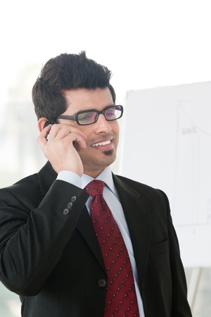 Indian businessman talking over the phoneの写真素材