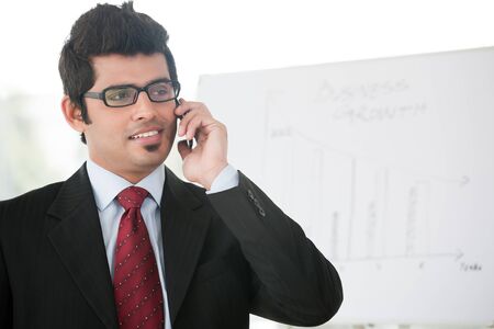 Indian businessman talking over the phoneの写真素材