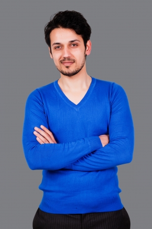 portrait of a handsome arab man wearing blue sweater, biracial man isolated on greyの写真素材