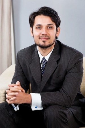 confident Indian businessman sitting on sofaの写真素材