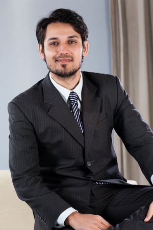 confident Indian businessman sitting on sofaの写真素材
