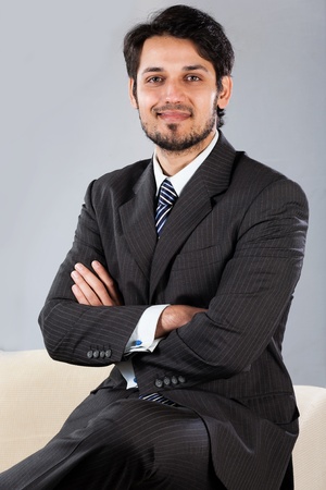 confident Indian businessman sitting on sofaの写真素材