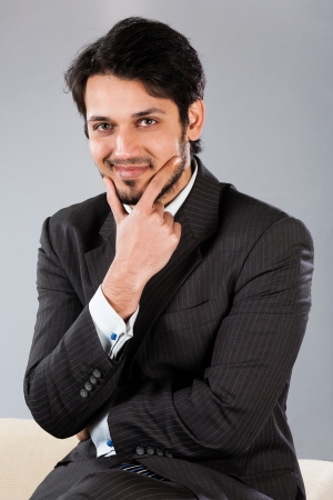 confident Indian businessman sitting on sofaの写真素材