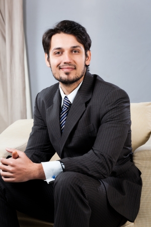 confident Indian businessman sitting on sofaの写真素材