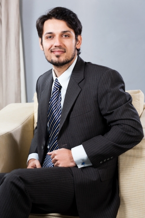 confident Indian businessman sitting on sofaの写真素材