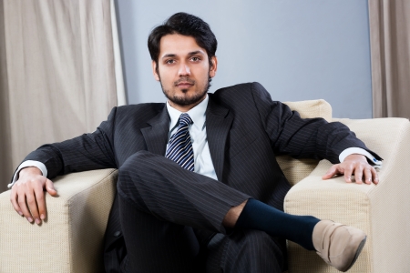 confiden businessman sitting on a sofaの写真素材
