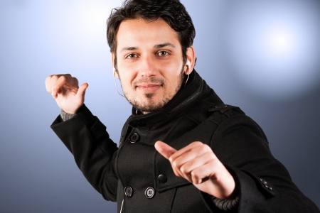 man listening music on head phones and dancingの写真素材
