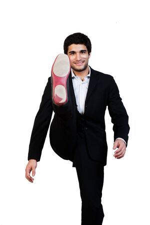 young businessman kicks in the air with aggression isolated on whiteの写真素材