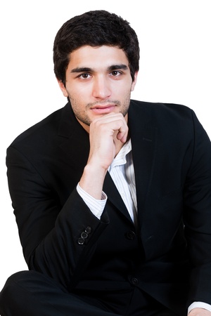 portrait of young happy businessman holding his chinの写真素材