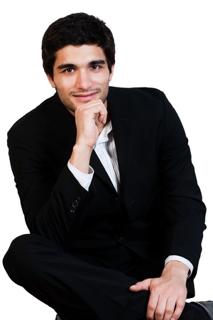 portrait of young happy businessman holding his chinの写真素材