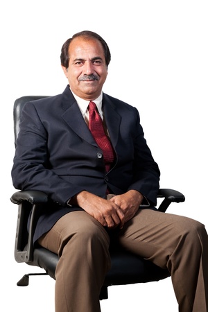 happy and confident senior businessman sitting in the office chair isolated on white backgroundの写真素材