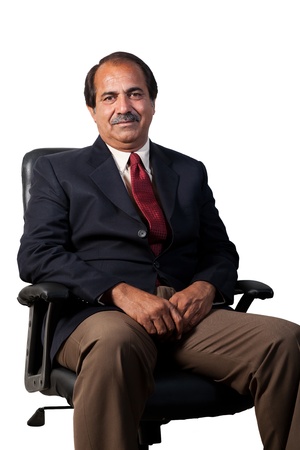 happy and confident senior businessman sitting in the office chair isolated on white backgroundの写真素材