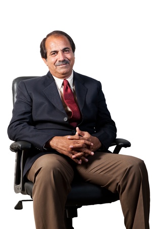 happy and confident senior businessman sitting in the office chair isolated on white backgroundの写真素材