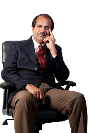 happy and confident senior businessman sitting in the office chair isolated on white backgroundの写真素材
