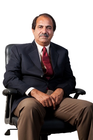 happy and confident senior businessman sitting in the office chair isolated on white backgroundの写真素材