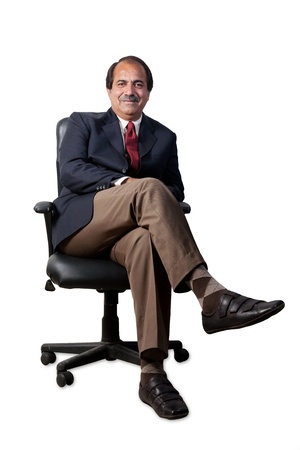 happy and confident senior businessman sitting in the office chair isolated on white backgroundの写真素材