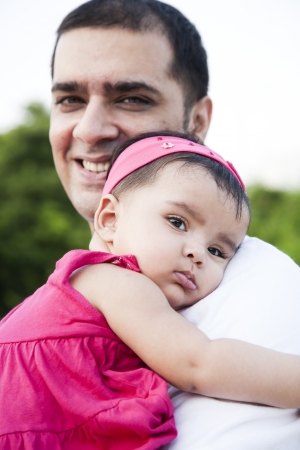 Portrait of a father holding the in his arms with love and affectionの写真素材