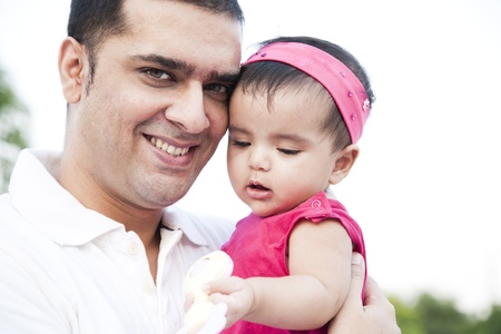 Portrait of a father holding the in his arms with love and affectionの写真素材