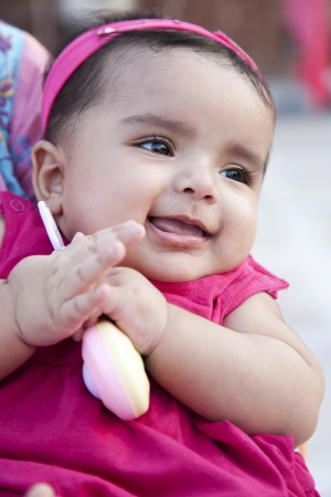 closeup of a little indian girl with a smile.の写真素材
