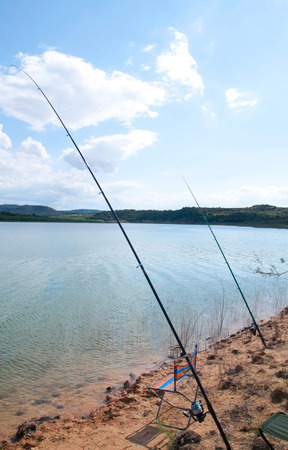 Fishing rods in the edge of the lakeの写真素材