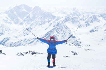 Elbrus, a mountaineer on the ascent, raised the trekking poles up