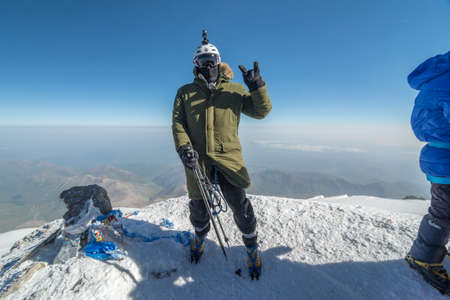 Caucasus / Russia - 07/31/2018 Group of climbers climbing mountain peaks.