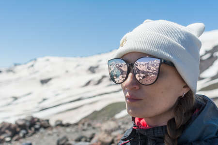 Caucasus / Russia - 02/06/2008 Group of climbers, acclimatization program in the mountains before climbing Mount Elbrus. Tourists take pictures on the background of high snowy mountain peaks.のeditorial素材