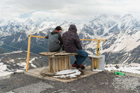 Caucasus / Russia - 02/06/2008 Group of climbers, acclimatization program in the mountains before climbing Mount Elbrus. Tourists take pictures on the background of high snowy mountain peaks.のeditorial素材