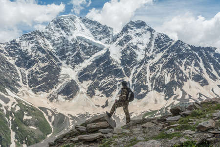 Caucasus / Russia - 22/06/2008 Group of climbers, acclimatization program in the mountains before climbing Mount Elbrus. Tourists take pictures on the background of high snowy mountain peaks.のeditorial素材