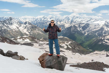 Caucasus / Russia - 02/06/2008 Group of climbers, acclimatization program in the mountains before climbing Mount Elbrus. Tourists take pictures on the background of high snowy mountain peaks.のeditorial素材