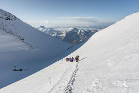 Caucasus / Russia - 07.23.2018 Group of climbers climbing mountain peaks.