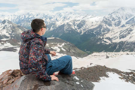 Caucasus / Russia - 02/06/2008 Group of climbers, acclimatization program in the mountains before climbing Mount Elbrus. Tourists take pictures on the background of high snowy mountain peaks.のeditorial素材