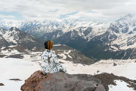 Caucasus / Russia - 02/06/2008 Group of climbers, acclimatization program in the mountains before climbing Mount Elbrus. Tourists take pictures on the background of high snowy mountain peaks.のeditorial素材
