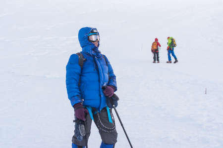 Caucasus / Russia - 07/31/2018 Group of climbers climbing mountain peaks.