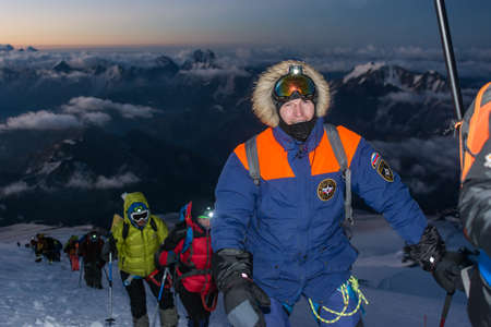 Caucasus / Russia - 06/08/2018 Group of climbers climbing mountain peak Elbrus
